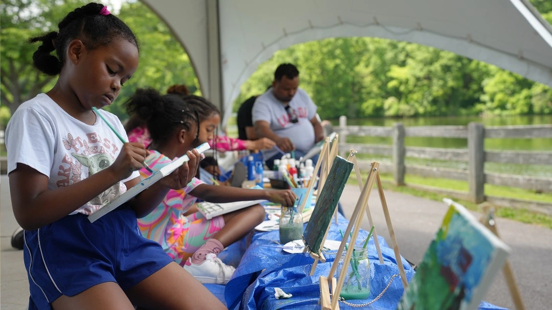 Children painting with brushes and bright colors